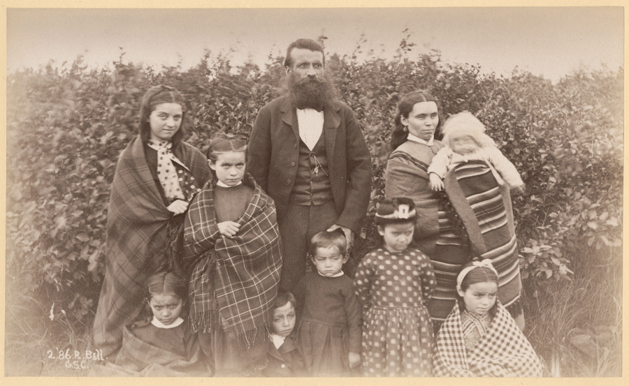 family of 10 wearing warm clothes and wrapped in blankets